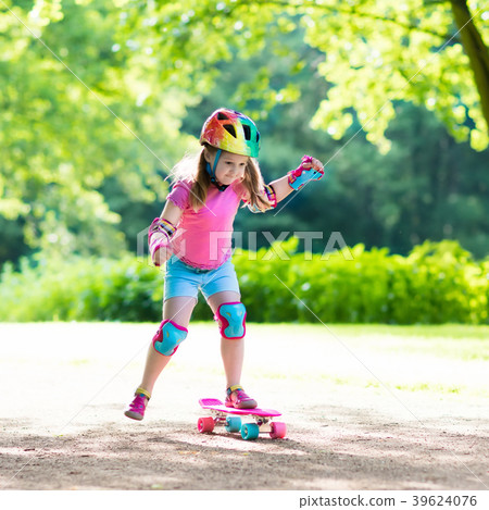 Child riding skateboard in summer park 39624076