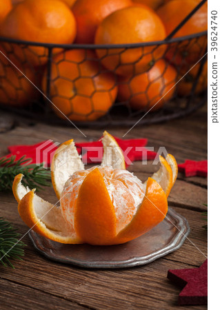 Peeled tangerine on the wooden table. 39624740
