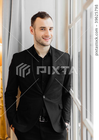 Stylish young bristle man is standing near the big 39625798