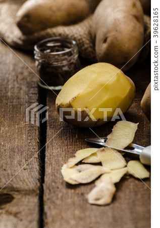 Peeling potatoes for gnocchi dougn on Peeling potatoes for gnocchi dougn on 39628165