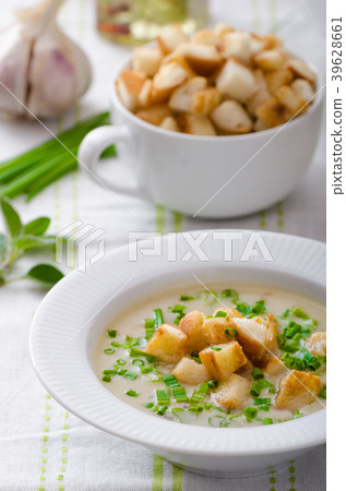 Garlic soup with croutons, spring onions and chives Garlic soup with croutons, spring onions and chives 39628661
