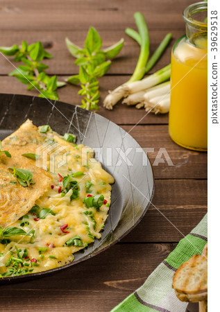 Cheese omelet with spring onions, herbs and chilli Cheese omelet with spring onions, herbs and chilli 39629518