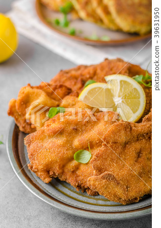 Delicious original schnitzel with potato pancakes 39631950