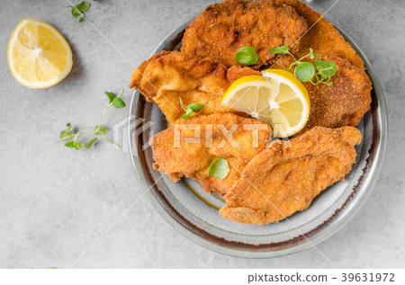 Delicious original schnitzel with potato pancakes Delicious original schnitzel with potato pancakes 39631972