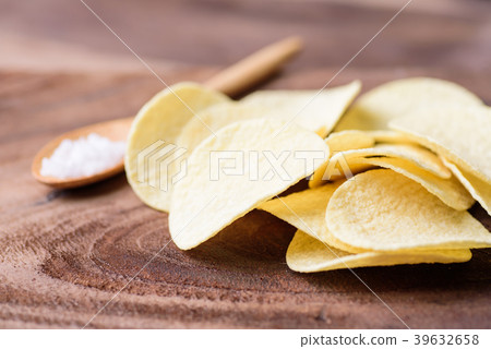Potato chips on wooden background Potato chips on wooden background 39632658