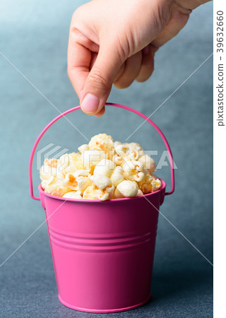 Hand carry a pink bucket of caramel popcorn Hand carry a pink bucket of caramel popcorn 39632660