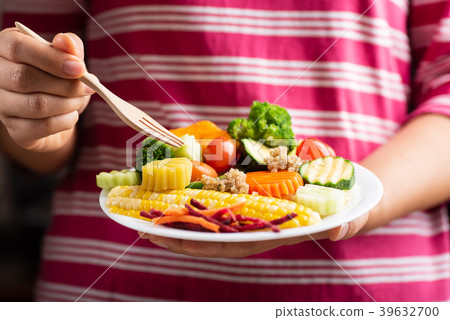 Woman eating vegetables salad, healthy food Woman eating vegetables salad, healthy food 39632700