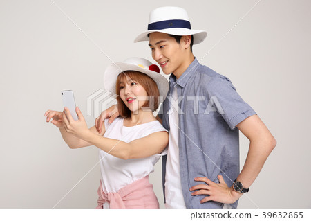 Happy young traveler couple concept photo. set out on a trip to honeymoon, camping and summer vacation concept isolated on white background. 424 Happy young traveler couple concept photo. set out on a trip to honeymoon, camping and summer vacation concept isolated on white background. 424 39632865