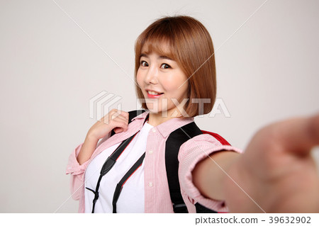 Young traveler woman with a backpack concept isolated on White photo. 056 Young traveler woman with a backpack concept isolated on White photo. 056 39632902