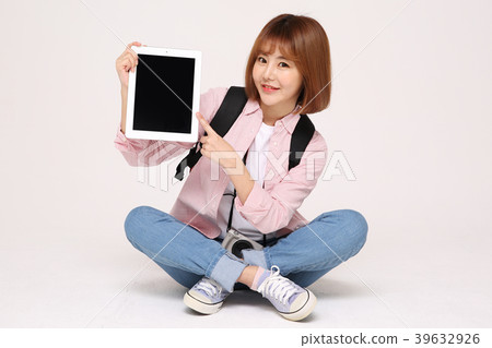 Young traveler woman with a backpack concept isolated on White photo. 113 Young traveler woman with a backpack concept isolated on White photo. 113 39632926