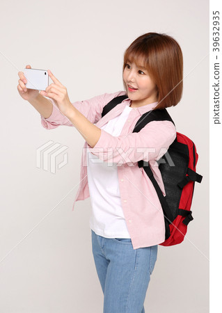 Young traveler woman with a backpack concept isolated on White photo. 093 Young traveler woman with a backpack concept isolated on White photo. 093 39632935