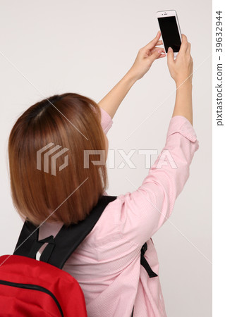 Young traveler woman with a backpack concept isolated on White photo. 090 Young traveler woman with a backpack concept isolated on White photo. 090 39632944