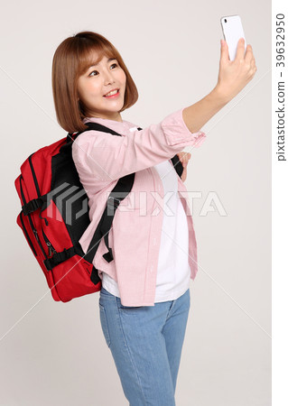 Young traveler woman with a backpack concept isolated on White photo. 086 Young traveler woman with a backpack concept isolated on White photo. 086 39632950