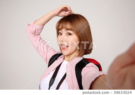 Young traveler woman with a backpack concept isolated on White photo. 057 Young traveler woman with a backpack concept isolated on White photo. 057 39633024