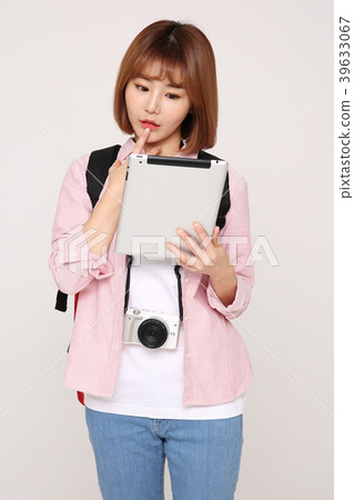 Young traveler woman with a backpack concept isolated on White photo. 101 Young traveler woman with a backpack concept isolated on White photo. 101 39633067
