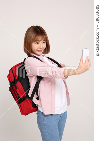 Young traveler woman with a backpack concept isolated on White photo. 085 Young traveler woman with a backpack concept isolated on White photo. 085 39633085