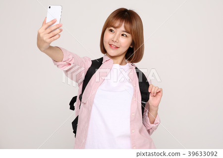 Young traveler woman with a backpack concept isolated on White photo. 082 Young traveler woman with a backpack concept isolated on White photo. 082 39633092