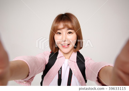 Young traveler woman with a backpack concept isolated on White photo. 058 Young traveler woman with a backpack concept isolated on White photo. 058 39633115