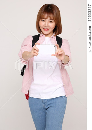Young traveler woman with a backpack concept isolated on White photo. 094 Young traveler woman with a backpack concept isolated on White photo. 094 39633237