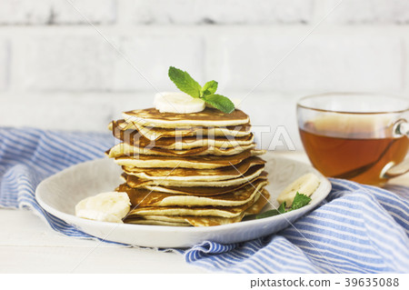 fresh baked pancakes with banana and tea fresh baked pancakes with banana and tea 39635088