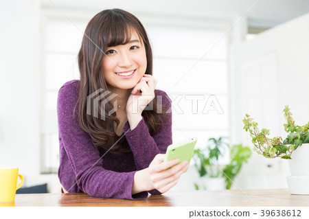 Woman looking at smartphone in the room Woman looking at smartphone in the room 39638612