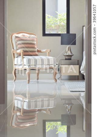 classic style lounge chair next to bedside table 39641057