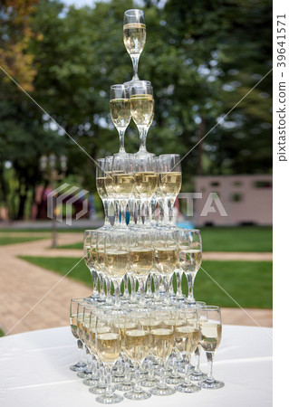 Champagne glasses standing in a tower at the party 39641571