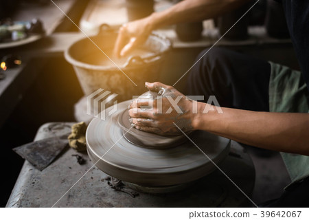 potter's hands shaping clay to make earthen pot potter's hands shaping clay to make earthen pot 39642067