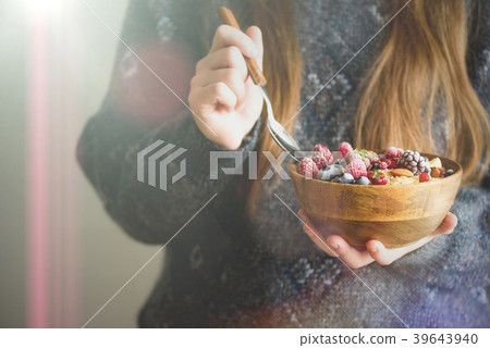 Woman hands holding oatmeal porridge with frozen Woman hands holding oatmeal porridge with frozen 39643940