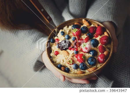 Woman hands holding oatmeal porridge with frozen Woman hands holding oatmeal porridge with frozen 39643947