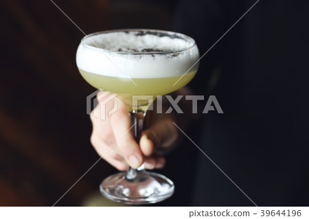 Daiquiri cocktail in female hand Daiquiri cocktail in female hand 39644196