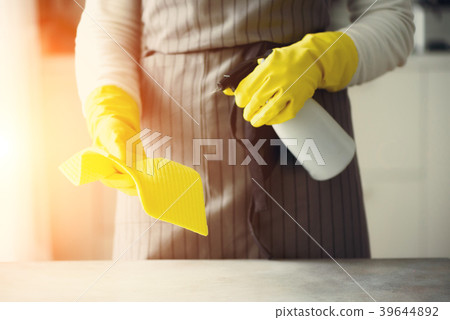 Woman in yellow rubber protective gloves wiping 39644892