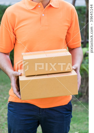 Delivery man in orange is handing packages Delivery man in orange is handing packages 39645144