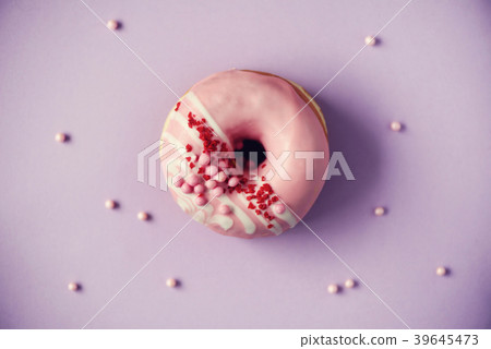 Sweet doughnut with purple icing on pastel Sweet doughnut with purple icing on pastel 39645473