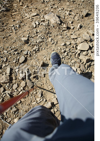 Photo of man in sneakers with walking stick Photo of man in sneakers with walking stick 39649206