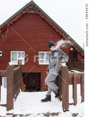 Traveller boy smoking outdoor in front of the wood 39649478