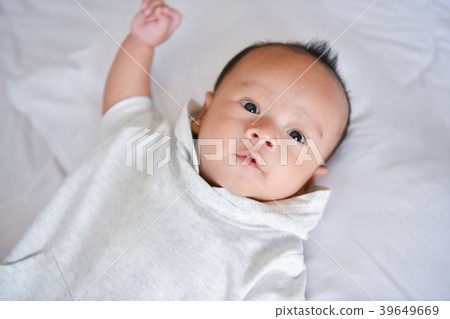 Newborn Concept. Mother and child on a white bed. Mom and baby b 39649669