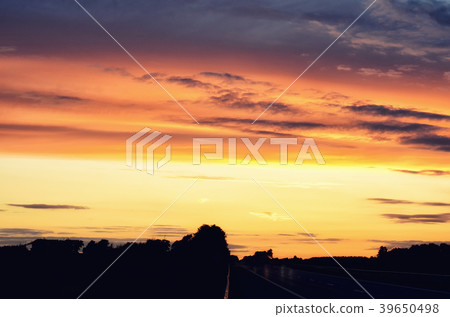 Empty asphalt road and sun rising on skyline Empty asphalt road and sun rising on skyline 39650498