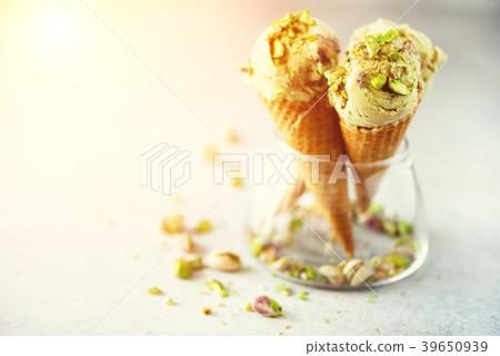Green ice cream in waffle cone with chocolate and Green ice cream in waffle cone with chocolate and 39650939