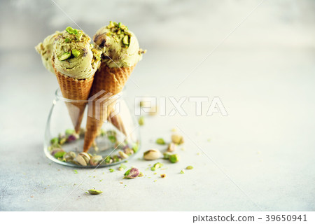 Green ice cream in waffle cone with chocolate and 39650941