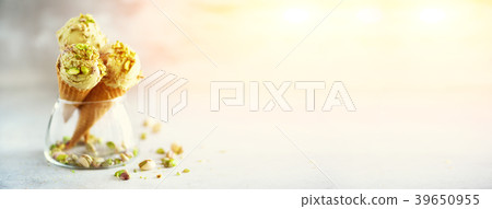 Green ice cream in waffle cone with chocolate and 39650955