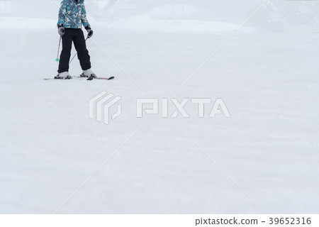 Skiers and snowboarders riding on a ski slope Skiers and snowboarders riding on a ski slope 39652316