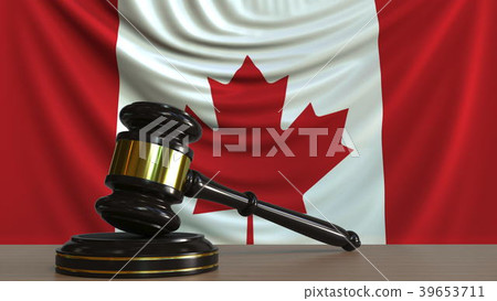 Judge's gavel and block against the flag of Canada 39653711