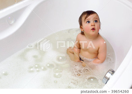 baby boy sitting in bath with water 39654260