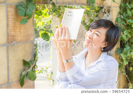 在前法國領事館讀書的女人仍然在一個丘陵公園,可以看到墜毀的港口 在前法國領事館讀書的女人仍然在一個丘陵公園,可以看到墜毀的港口 39654725