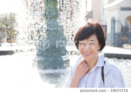A woman enjoying in the English garden in the ga hill park with a view of the harbor 39655558