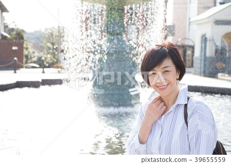 A woman enjoying in the English garden in the ga hill park with a view of the harbor A woman enjoying in the English garden in the ga hill park with a view of the harbor 39655559
