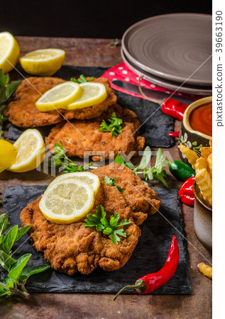 Schnitzel with fries, salad and herbs Schnitzel with fries, salad and herbs 39663190