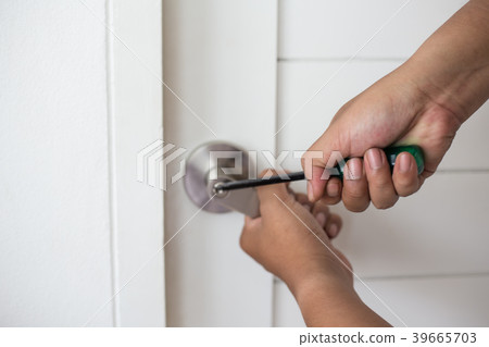 Thief with a screwdriver hand to open a door Thief with a screwdriver hand to open a door 39665703