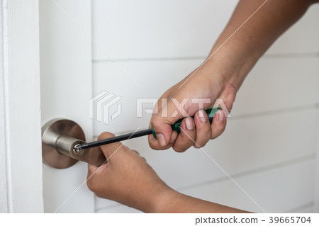 Thief with a screwdriver hand to open a door Thief with a screwdriver hand to open a door 39665704